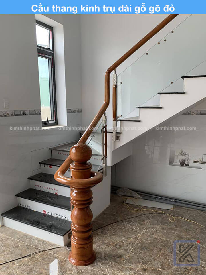 Cầu thang kính trụ dài gỗ gõ đỏ